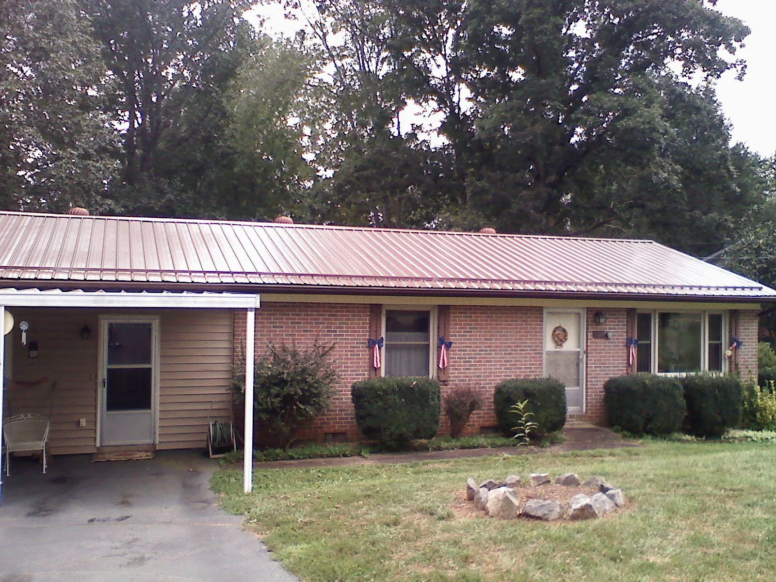 Bronze metal roof and carport on a brick ranch home — Roof Repair work by our crew in West Suffield