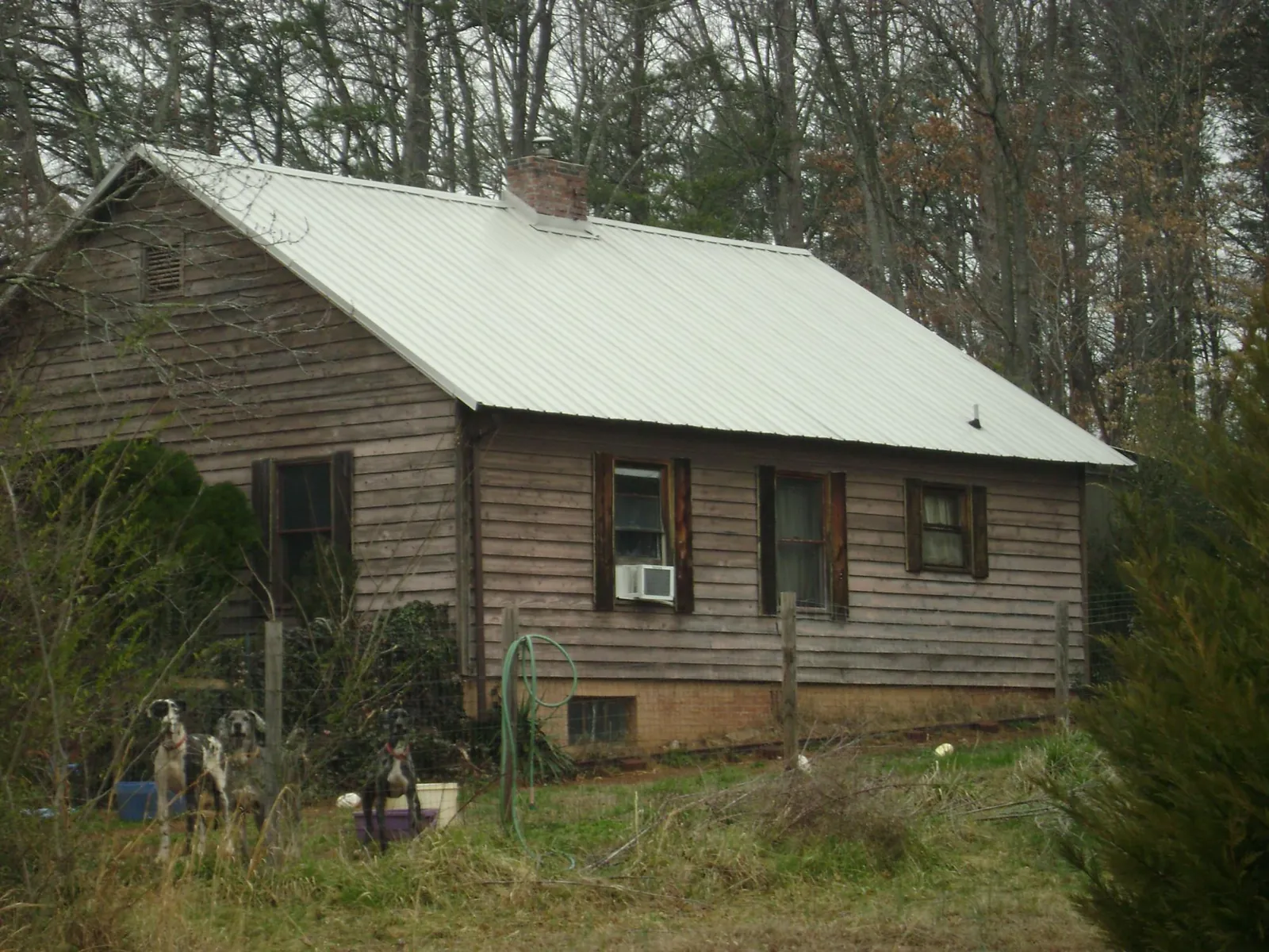 White metal roof on an old wood sided farmhouse, from a Metal Roof Installation job in West Suffield